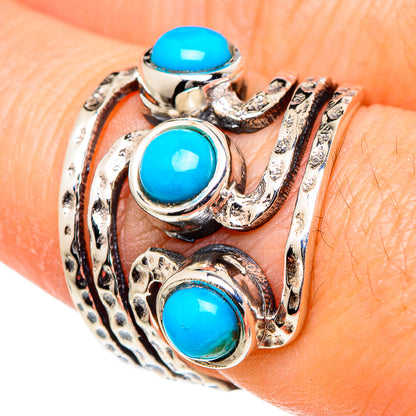 Turquoise oval cabochon 925 sterling silver ring with ornate swirl setting, close-up