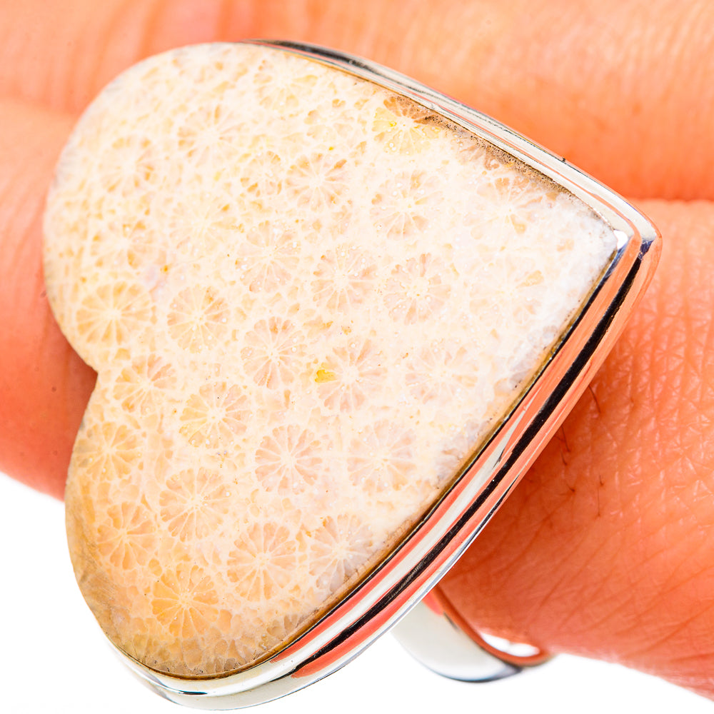 Heart-shaped 925 sterling silver ring with fossil coral inlay, close-up textured gold.