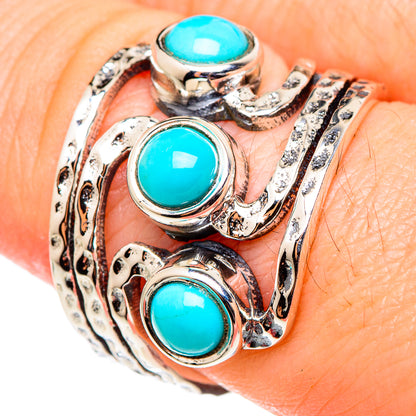 Turquoise cabochon sterling silver ring with ornate metalwork and three turquoise stones