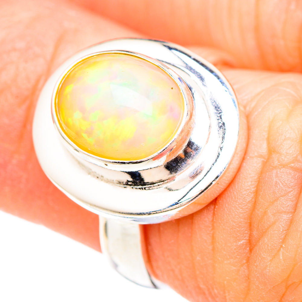 Oval yellow opal set in polished 925 sterling silver ring with curved band