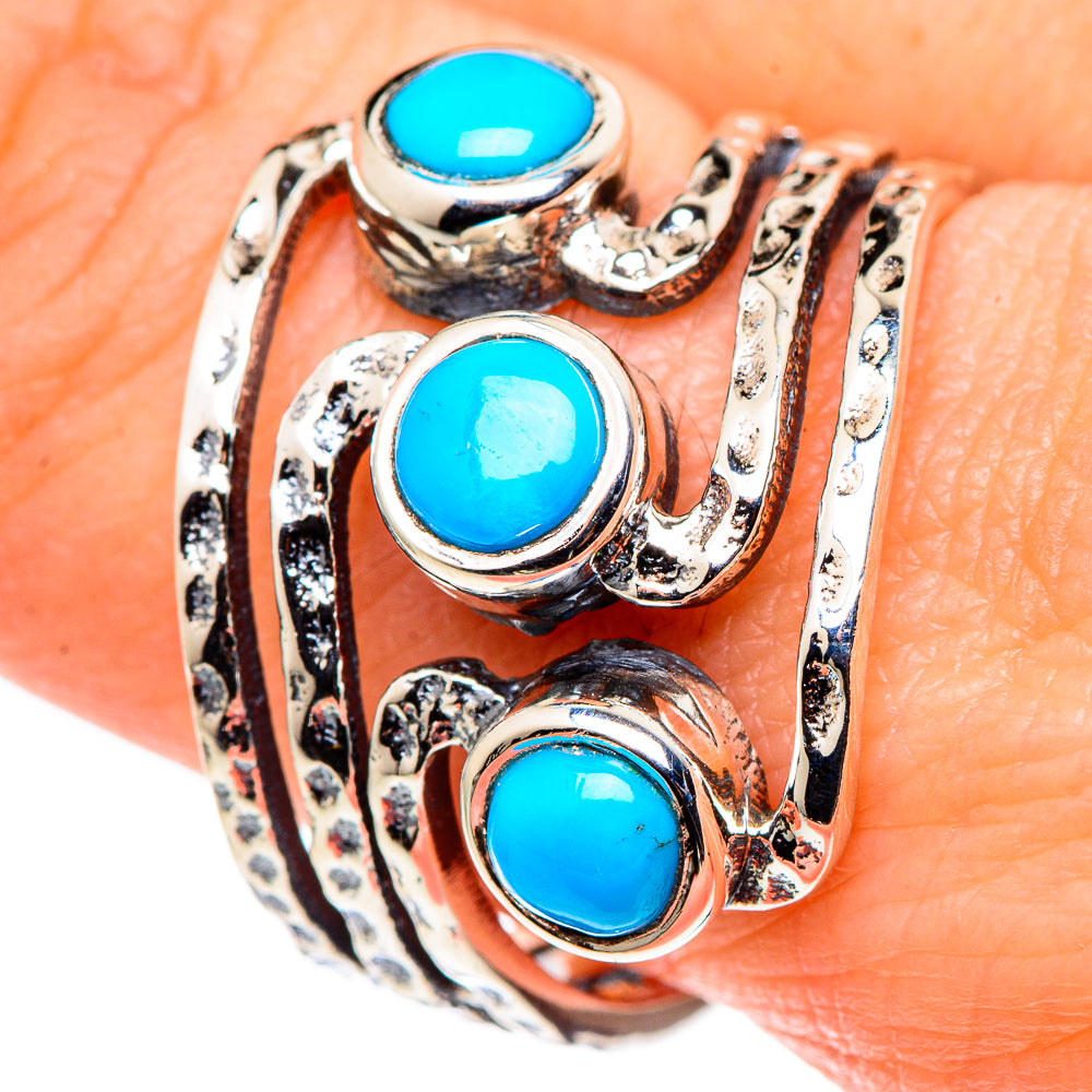 Turquoise cabochon statement ring on hand, three blue stones in silver scrollwork