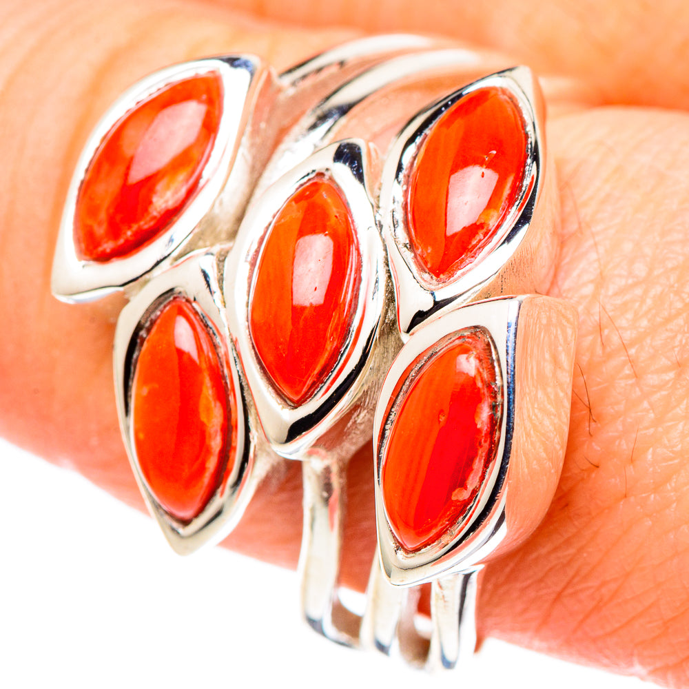Sterling silver coral ring close-up, oval orange-red stones in bezel settings