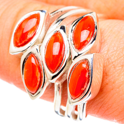 Sterling silver coral ring close-up, oval orange-red stones in bezel settings