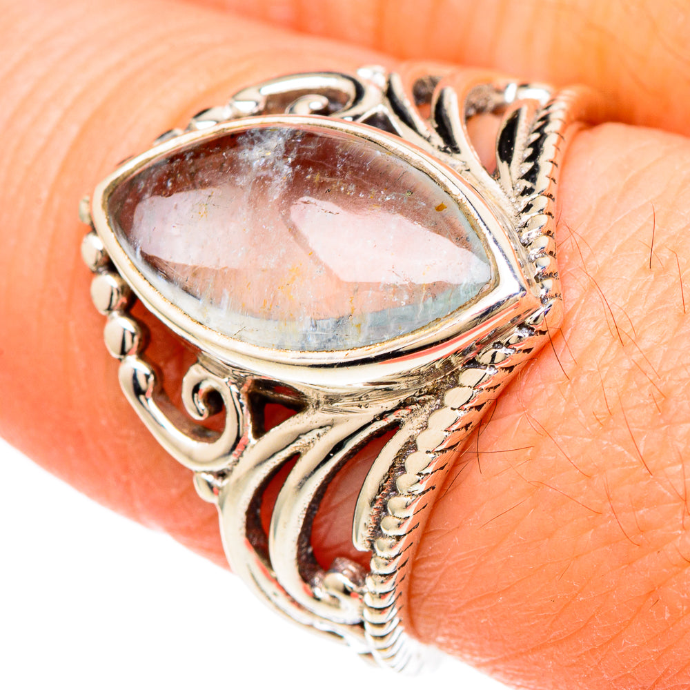 Sterling silver ring with oval bezel and detailed scrollwork around a gemstone