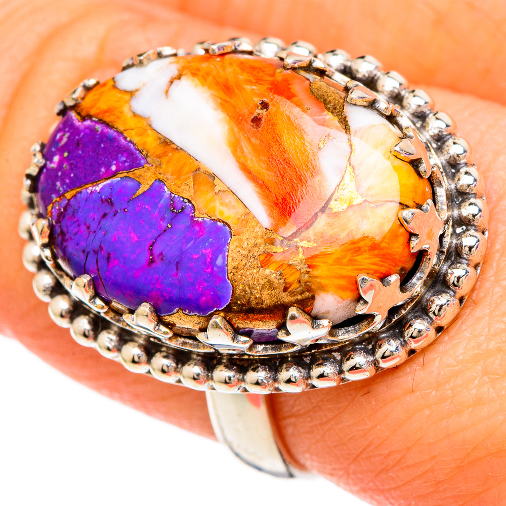 Spiny oyster inlay ring close-up with oval orange, white, and purple cabochon, silver beaded rim