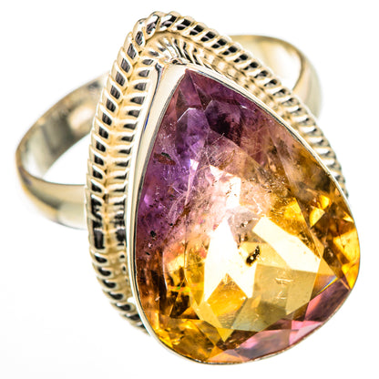 Pear-cut ametrine ring with faceted purple-to-yellow stone, polished metal setting and braided band