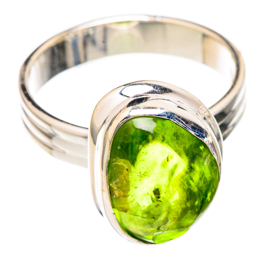 Sterling silver ring featuring oval green peridot, sculpted bezel and open band