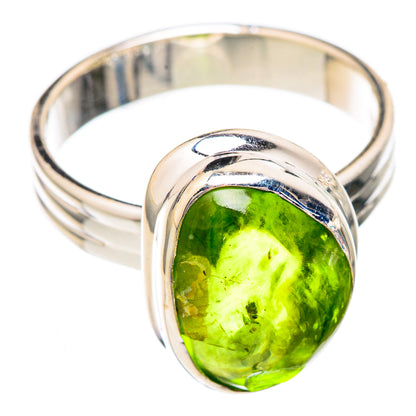 Sterling silver ring featuring oval green peridot, sculpted bezel and open band