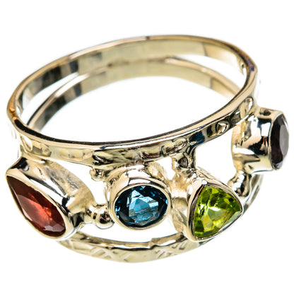 Sterling silver ring with blue center, green accents, red marquise, and dark stone
