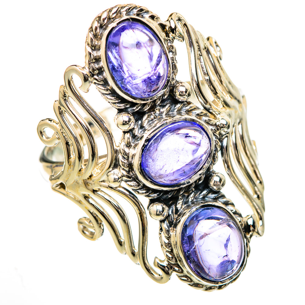 Three oval blue tanzanite stones on gold and silver-toned scrollwork ring