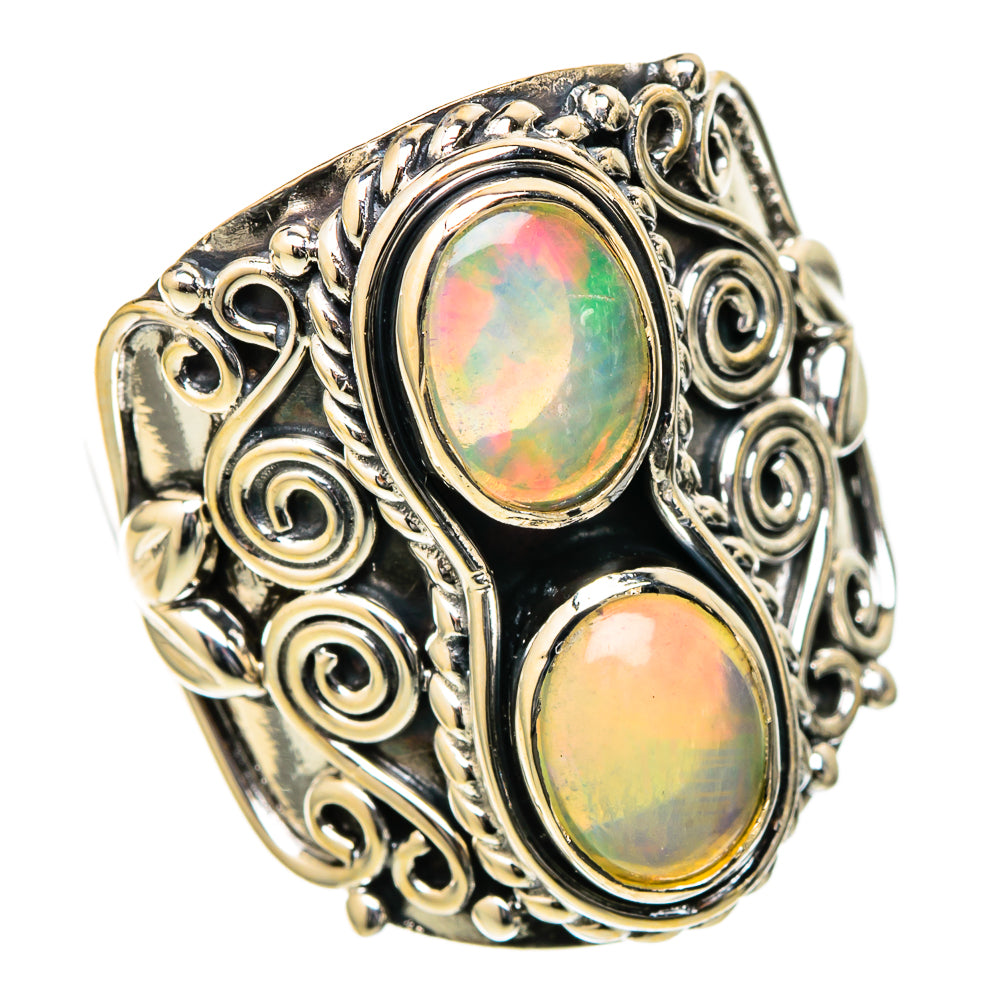 Sterling silver opal ring with two oval opal cabochons and swirling filigree setting