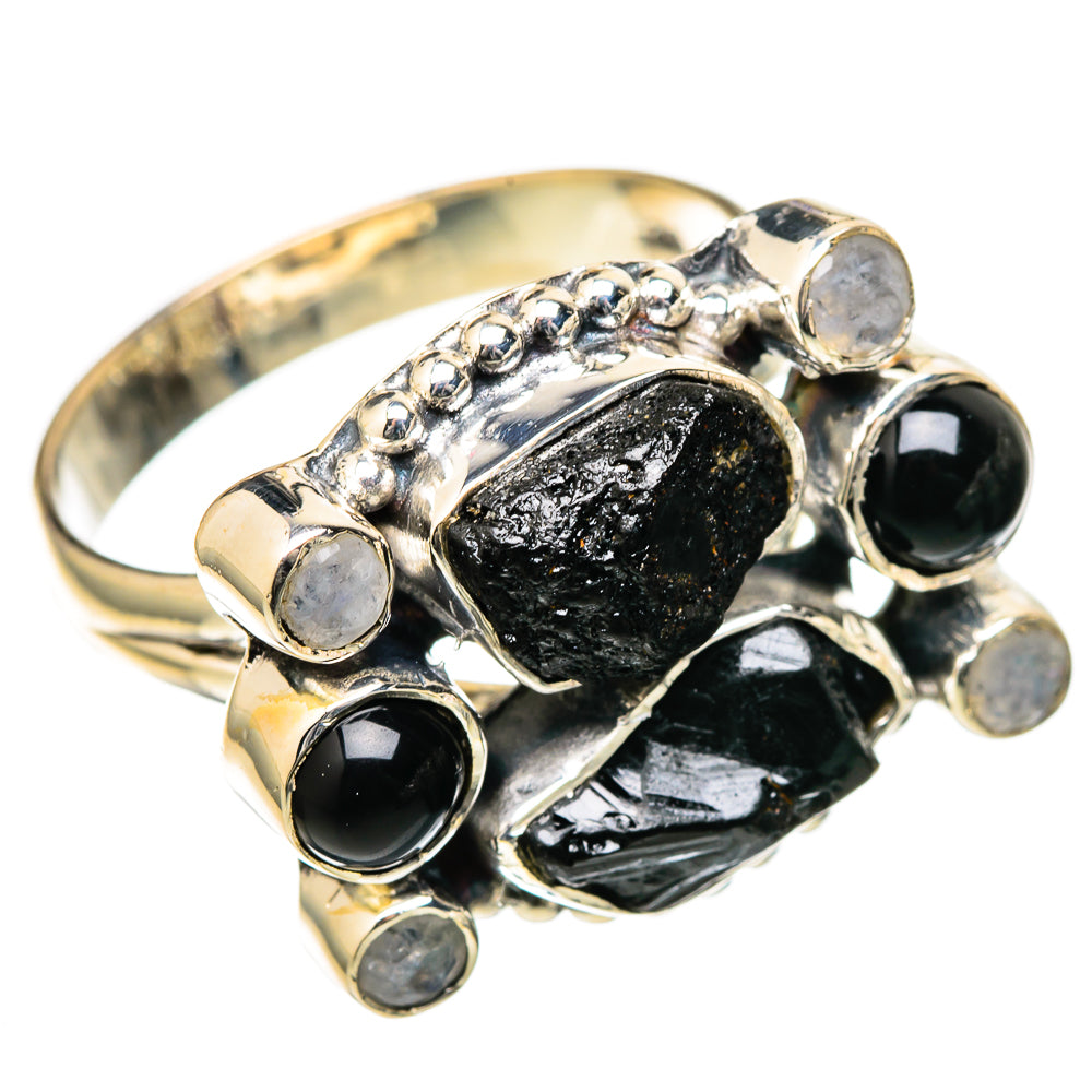 Sterling silver ring with oval black center stone and several round pale iridescent gems