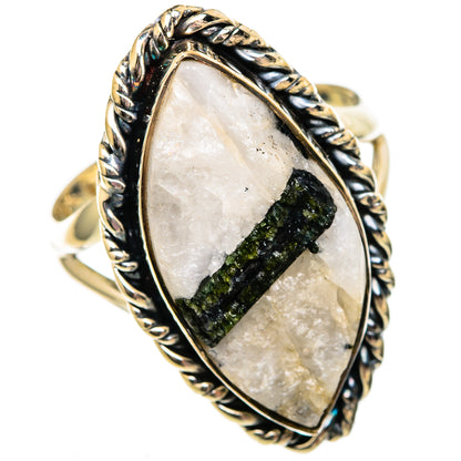 Green tourmaline in clear quartz oval ring with silver twisted rope frame.