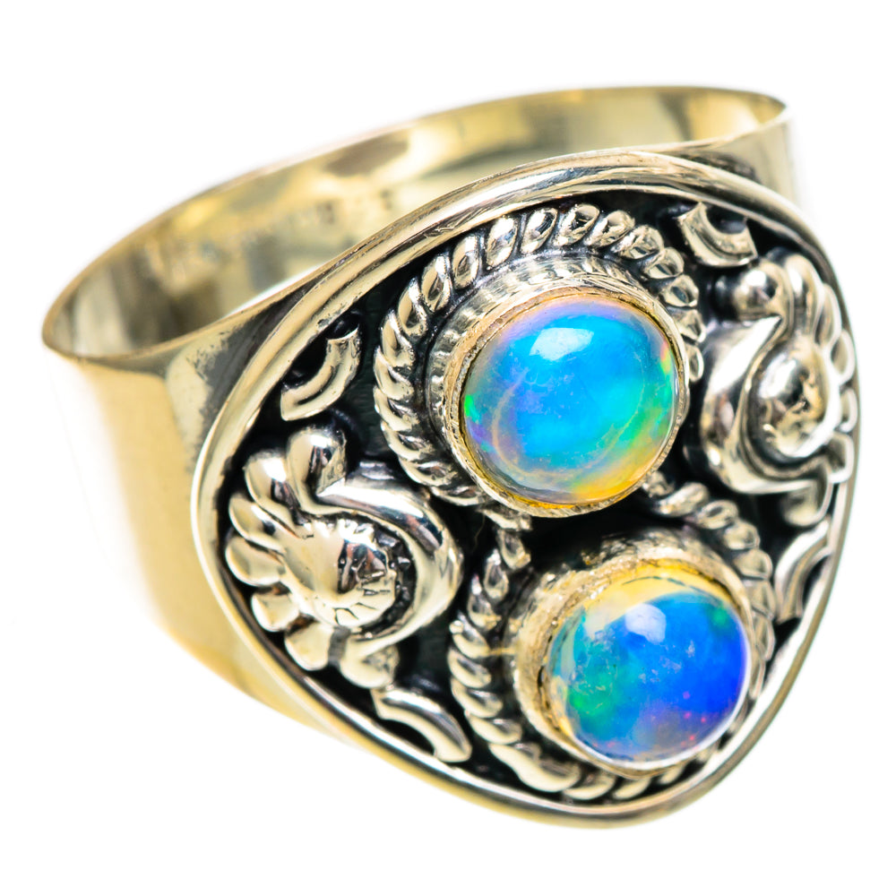 Gold-toned opal ring with two blue-green oval stones and ornate filigree border