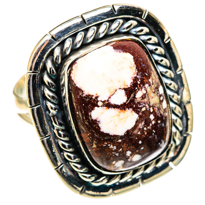 Silver oval jasper cabochon ring with braided metal border and heart mottling