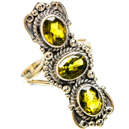 Sterling silver tourmaline ring with three oval green gemstones in ornate settings