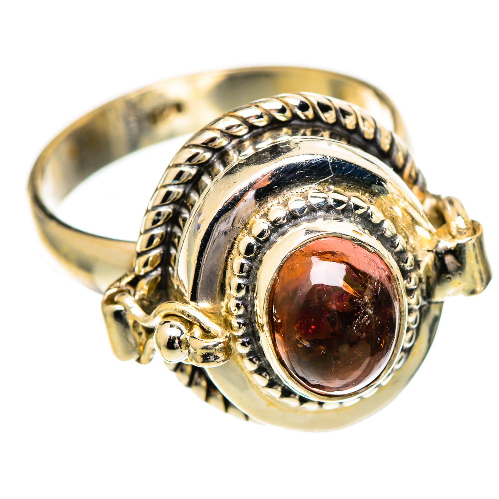 Sterling silver ring with oval reddish gemstone, scalloped frame and openwork band