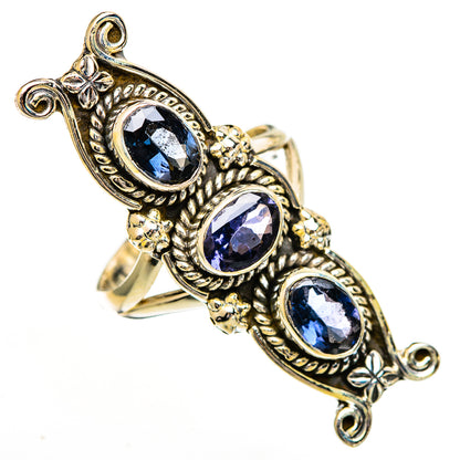 Gold-tone ornate ring with three oval blue faceted stones