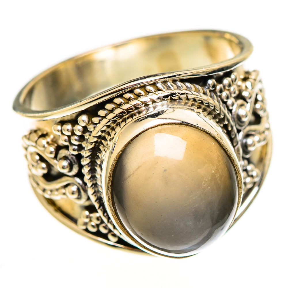 Gold-tone sterling silver ring with oval reflective cabochon and raised filigree band
