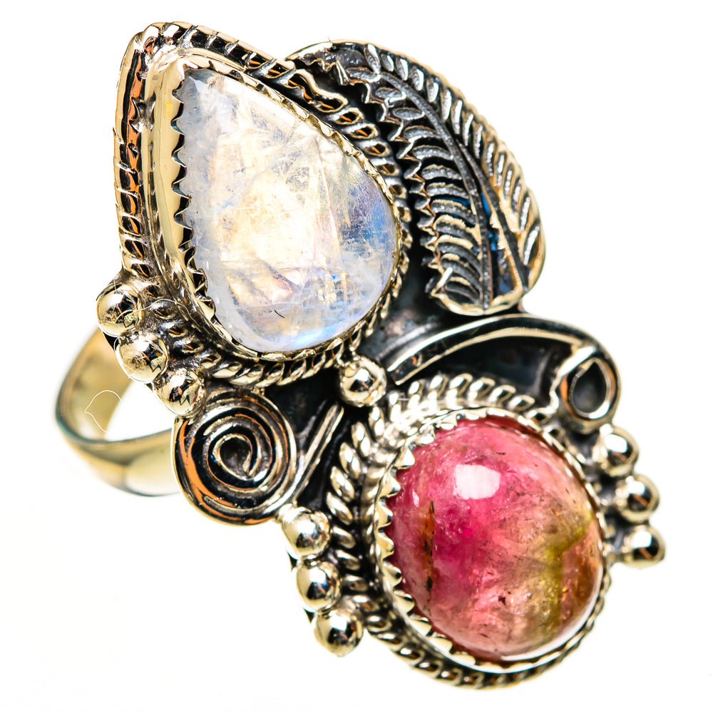 Ornate sterling silver ring featuring oval rainbow moonstone and red-pink tourmaline cabochon