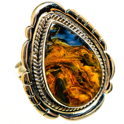 Oval pietersite cabochon ring with ornate silver frame and gold-toned stone