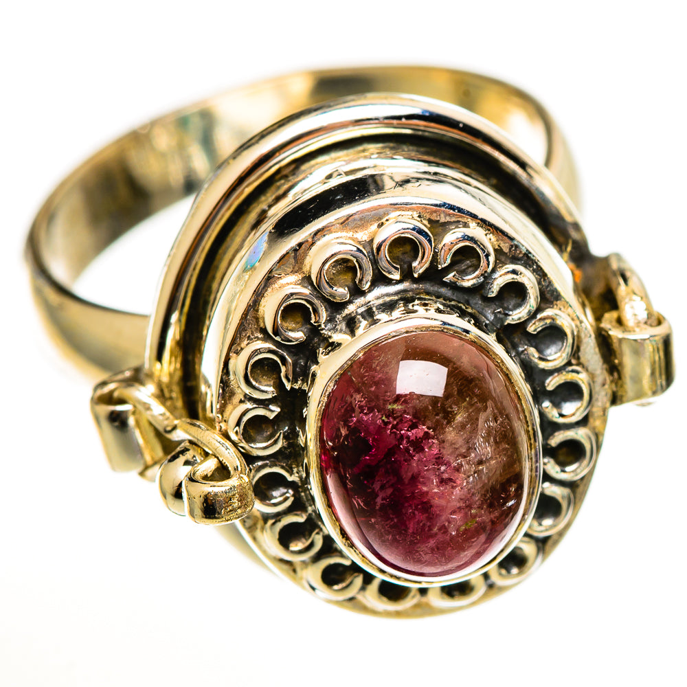 Gold-tone oval gemstone ring with filigree halo, pink tourmaline cabochon