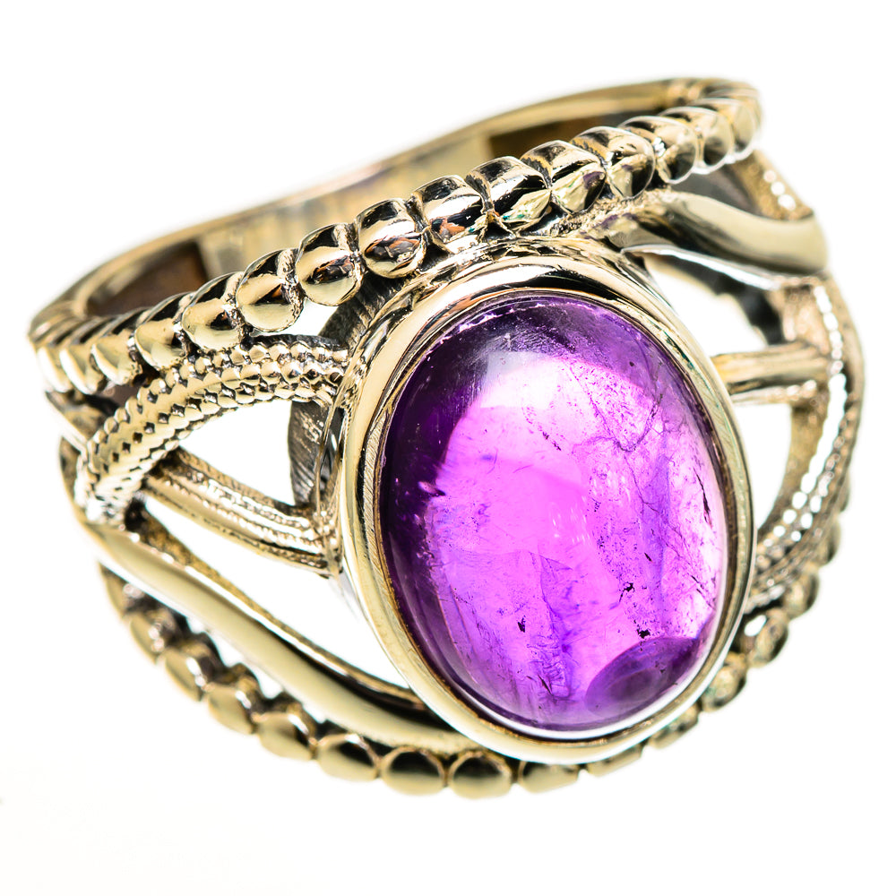 Amethyst oval gemstone ring with gold-tone filigree band and decorative halo setting