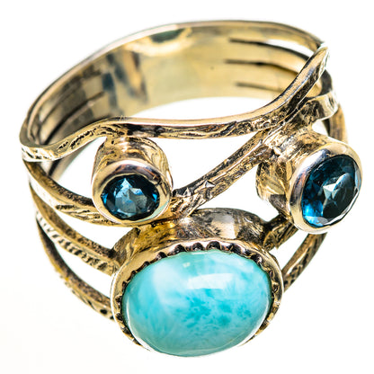 Sterling silver ring with oval larimar cabochon and two blue topaz-like stones