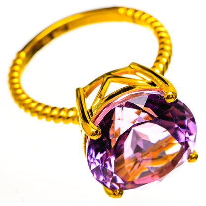 Gold-tone amethyst ring with large faceted round stone and four prongs