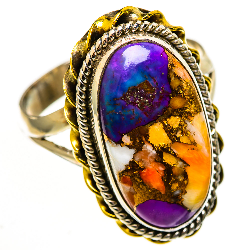 Oval turquoise-style ring, purple-blue center with orange/gold matrix, rope border bezel