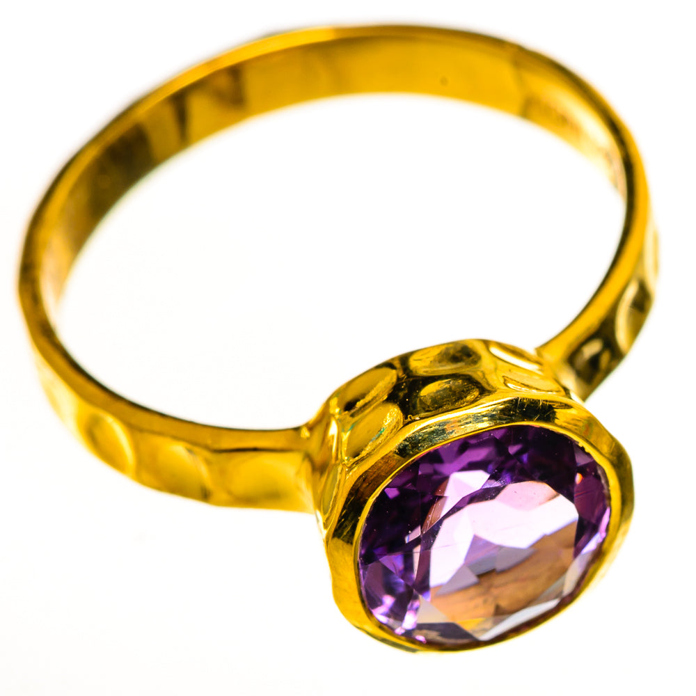 Gold-plated faceted amethyst ring with oval purple gemstone, polished band