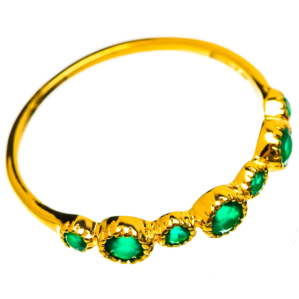 Gold plated ring with five green oval gemstone settings along a slim band