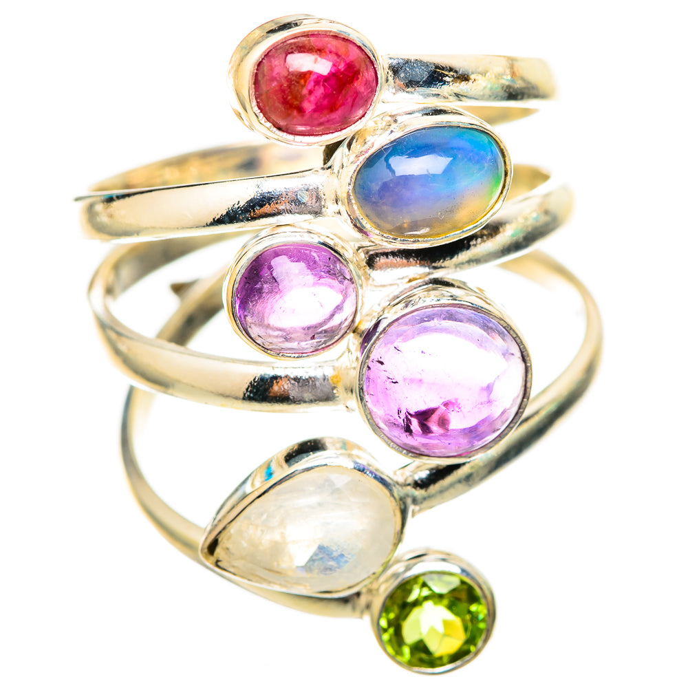 Silver-tone ring with oval and round gemstones: red, blue, purple, white, and green.