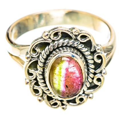 Gold-tone ring with oval pink-green-red gemstone and detailed filigree bezel
