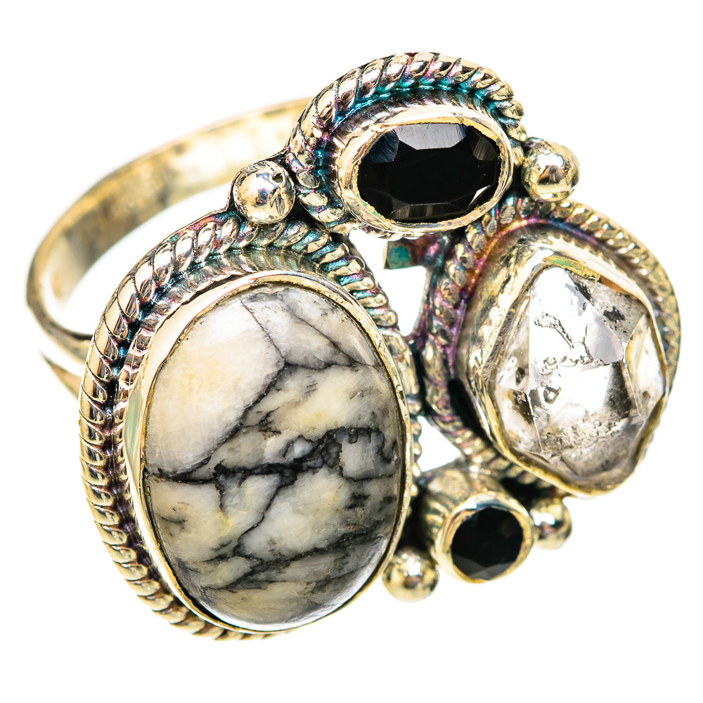 Silver ring with oval marbled stone, black onyx, and clear crystal accents, braided bezels