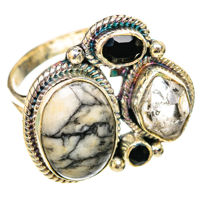 Silver ring with oval marbled stone, black onyx, and clear crystal accents, braided bezels