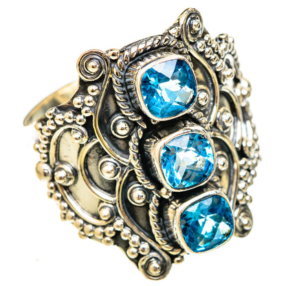 Ornate sterling silver ring with three round blue topaz stones in claw settings