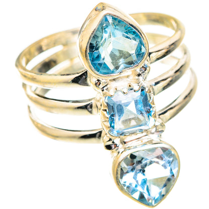 Three-stone blue gemstone ring with teardrop and oval cuts, gold-tone band view