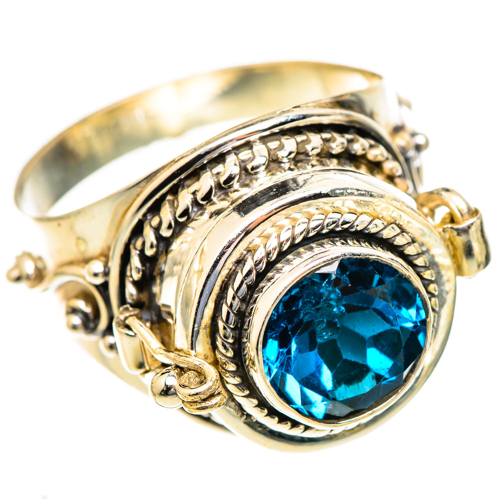 Silver-tone ring with oval blue gemstone bezel and ornate rope-style filigree detail