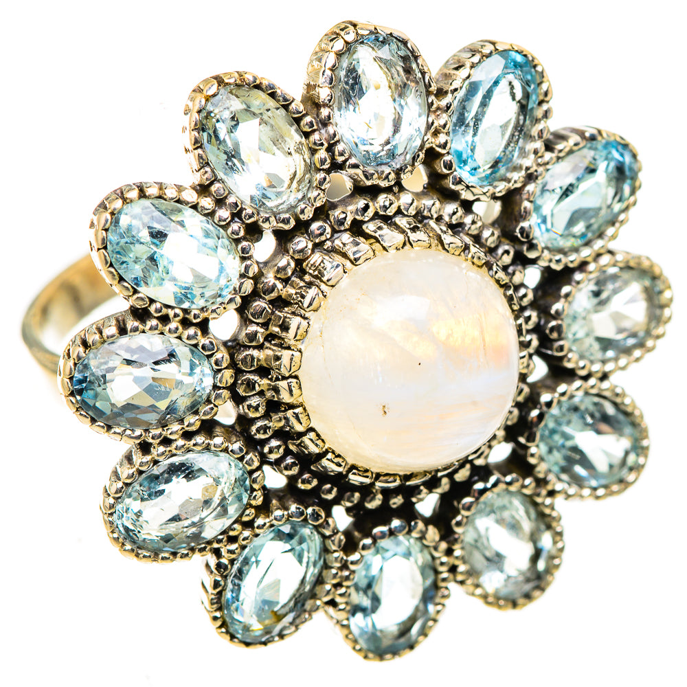 Large opal-like moonstone center ring with oval blue stones in ornate silver setting