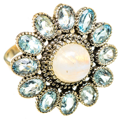 Large opal-like moonstone center ring with oval blue stones in ornate silver setting