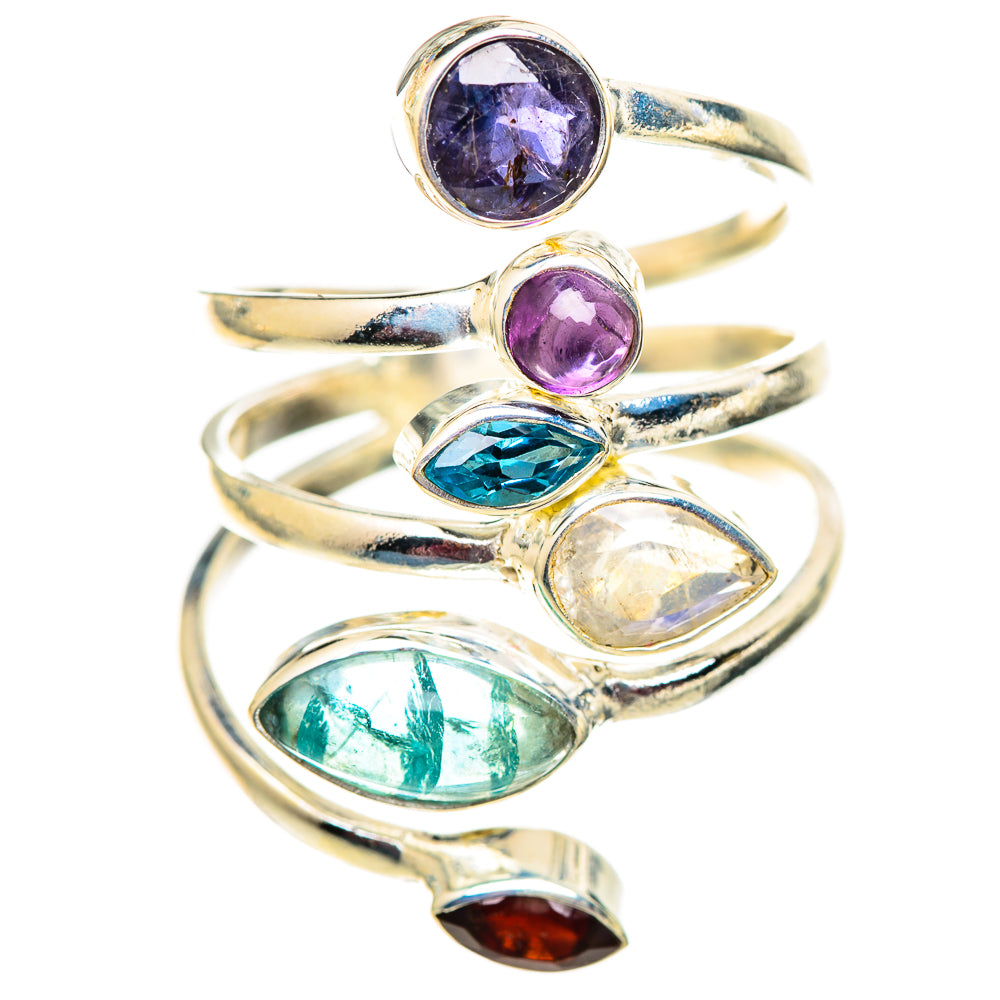 Silver multi-stone ring with oval purple, blue, green and red gemstones on a curved band