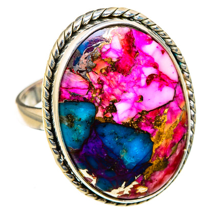 Oval gemstone ring with vivid pink, teal, and gold pattern, rope-edged bezel