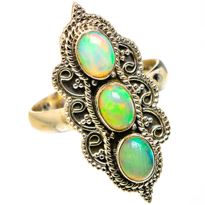 Opal triple oval gemstone ring with ornate gold-toned filigree setting, size 10.