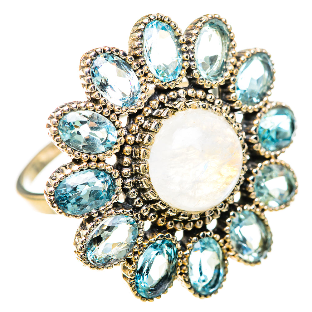 Rainbow moonstone center with blue oval stones and ornate halo design, silver ring