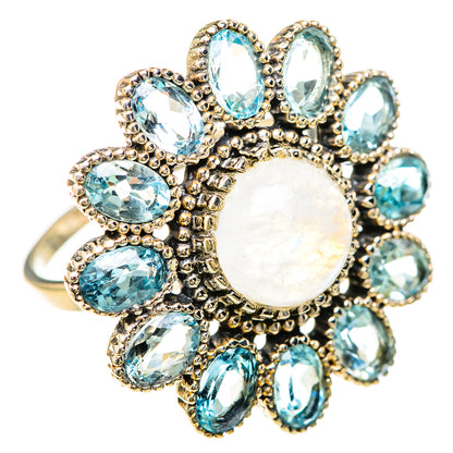 Rainbow moonstone center with blue oval stones and ornate halo design, silver ring
