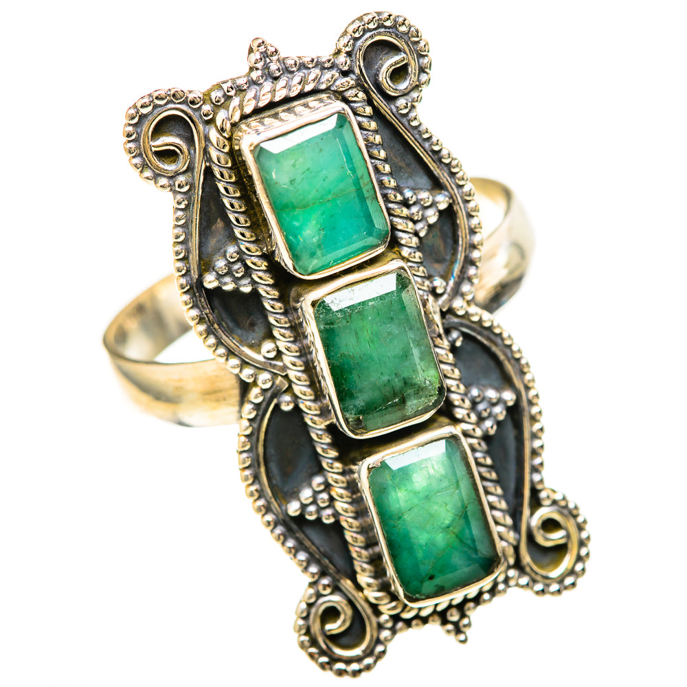 Large emerald-cut green stones in ornate sterling silver ring with dark blue panels