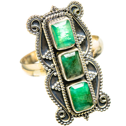 Gold-tone ring with three square green stones in an ornate beaded halo setting