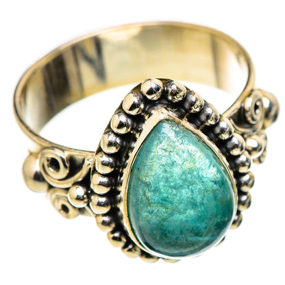 Gold-tone statement ring with oval teal cabochon and bead-and-scroll setting