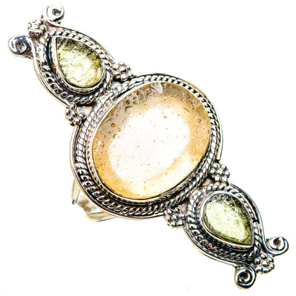 Sterling silver oval gemstone ring with textured halo and two smaller green stones